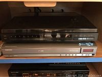 View of BSR XL-1400 turntable stacked on top of Samsung DVD changer showing front control panels and branding.