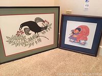 Two framed prints side by side on carpet
