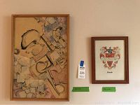 Two framed art pieces hanging on a wall: a 25x27 mixed media abstract art piece by Mark Hopkins on the left and a smaller framed Kincaid Coat of Arms painting on linen sized 13.5x10.5 on the right.