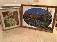 Two framed oil paintings leaning against a low table; larger landscape signed H. Peterson, smaller floral signed Via Walling Draper.