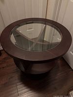 Full view of round wood and glass end table