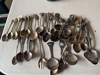 Group shot of entire lot showing quantity and variety of spoons and fork