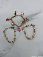 Overall view of three bracelets in lot