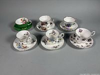 All six teacup and saucer sets displayed