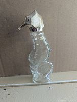 full view of glass seahorse bottle standing upright