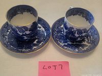 Two flow blue Willow teacups and saucers