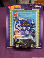 Front view of sealed Hot Wheels Disney Sleeping Beauty Super Van on damaged card