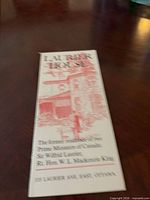 Front cover English side of Laurier House brochure showing illustration and address