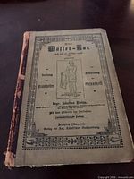 Front cover showing title, illustration and worn spine