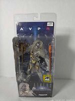 Front view of sealed AVPR Predator figure in clamshell with SDCC sticker