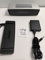 Speaker, charging cradle, power adapter with cable laid out