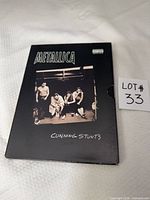 Front of slipcase showing title, band photo, parental advisory logo