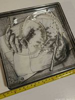 Top view showing artwork, rings and ball bearings with tape measure indicating size