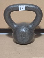 Front view of grey cast iron kettlebell showing integrated handle and overall condition