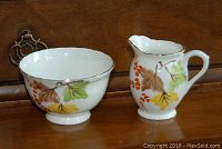 Photo of Pinetree translucent china creamer and sugar bowl with autumn leaves and berries decoration.