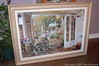 Framed garden print showing a garden viewed through open French doors, with gold and white detailed frame