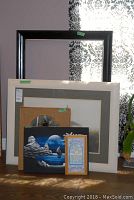 Six items including large print of lighthouse, white framed burlap design with mirror, whimsical framed print, and smaller prints and empty frame all shown together