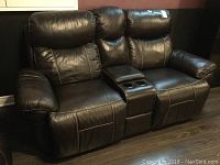 Front view of two-seat loveseat showing upholstery, armrests and central console