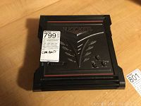 Top view of black Kicker ZX150.2 amplifier with embossed logo and red accent stripes, showing condition and design.