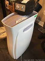Filtrete air purifier white unit with side handle and top vent grille, sits on floor