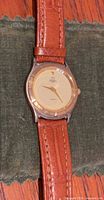 Front view of watch showing dial, bezel, brand