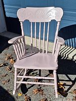 Full view of pink wooden pressback rocking chair