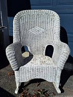 Front view of white wicker rocking chair showing full structure
