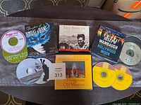 Overall view of all audiobook cases and loose music CDs on table