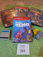 Full lot overview showing four PS2 games, grey Game Hunter card, dark grey memory card