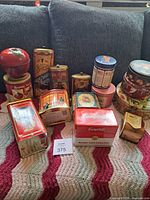 All tins grouped on blanket