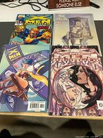All four bagged comics laid out face-up