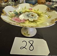 Angled view of pedestal compote showing floral interior and gold trim rim