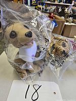 Two sealed Taco Bell talking Chihuahua plush toys in original plastic bags