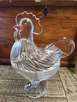 Front view of clear glass hen candy dish showing full shape, lid, pedestal foot