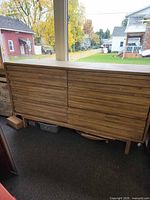 Front view showing full dresser, six louvered drawers, tapered legs