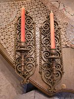 Full view of both Burwood scroll wall sconces with candles displayed