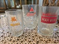 All three advertising glass mugs side by side