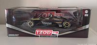 Front view of boxed GreenLight 1:18 IndyCar model showing black and gold livery and limited edition label