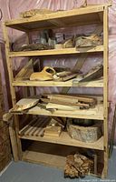 full shelving unit loaded with mixed hardwood slabs, burls, blanks, offcuts