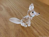 Three-quarter view of complete fox figurine showing faceted body and frosted tail