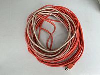 Coiled orange extension cord overall view