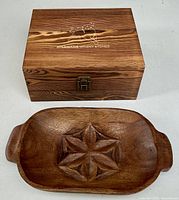 Closed engraved wooden box and carved bowl top view
