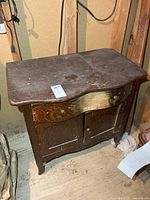 Front view of wooden washstand cabinet showing drawer and doors