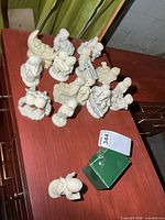 Overhead view of entire group of Snowbabies figurines and green box