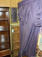 Shelf beside curtain showing height relative to surrounding furniture