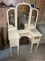 Full view of painted vanity with tri-fold mirror