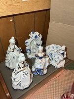 Group of five porcelain lady figurines displayed together