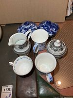 Group view of creamer, sugar, two mugs, teacup, two cobalt covered dishes