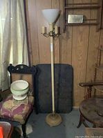 Full view of vintage cream/off-white torchiere floor lamp with three candle arms and milk glass shade