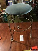 Full view of stool showing frame, casters, seat